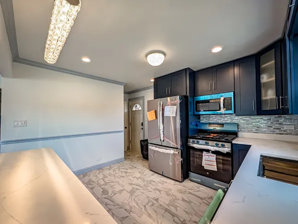 a kitchen with refrigerator and microwave