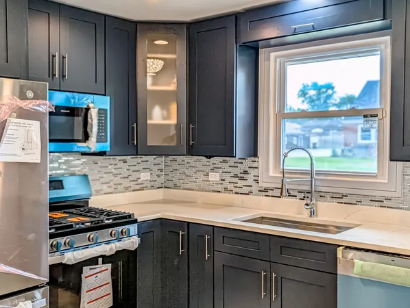 a kitchen with a sink stove and cabinets