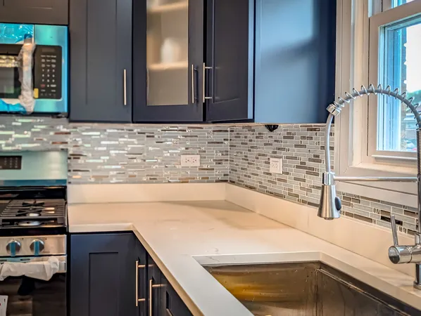 a kitchen with a sink and a refrigerator
