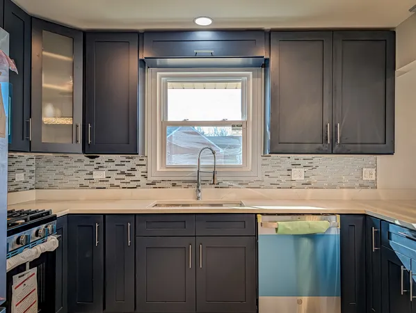 a kitchen with granite countertop a sink and a window