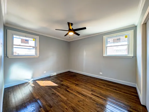 a view of room with wooden floor and ceiling fan