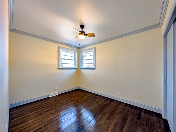 a view of an empty room and wooden floor