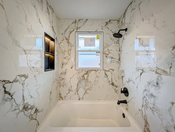 a bathroom with a bathtub and shower
