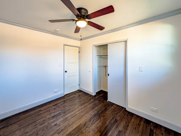 a spacious bathroom with a toilet a sink and mirror