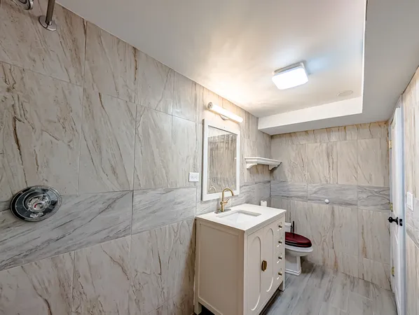 a bathroom with a sink a toilet and a mirror