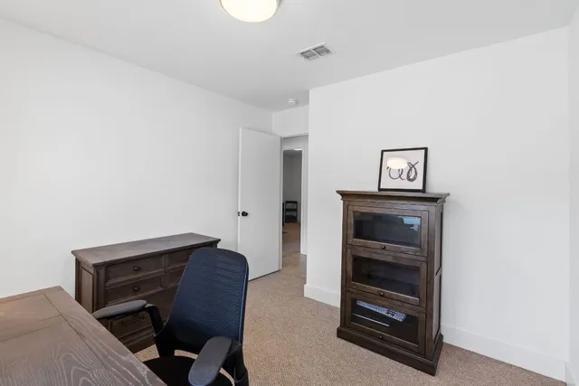 a room with a chair and a dresser