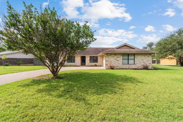 a front view of a house with a garden