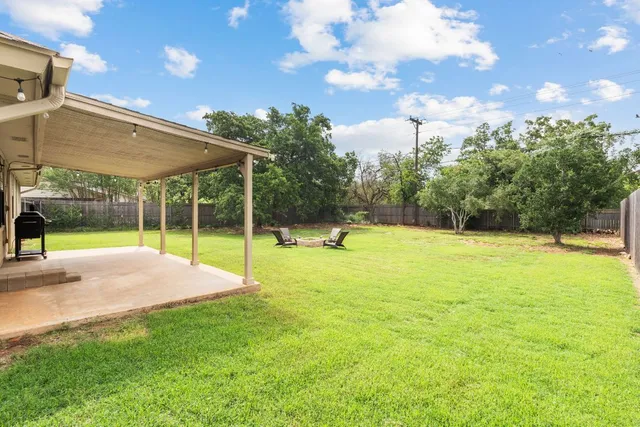 a view of a swimming pool with a yard