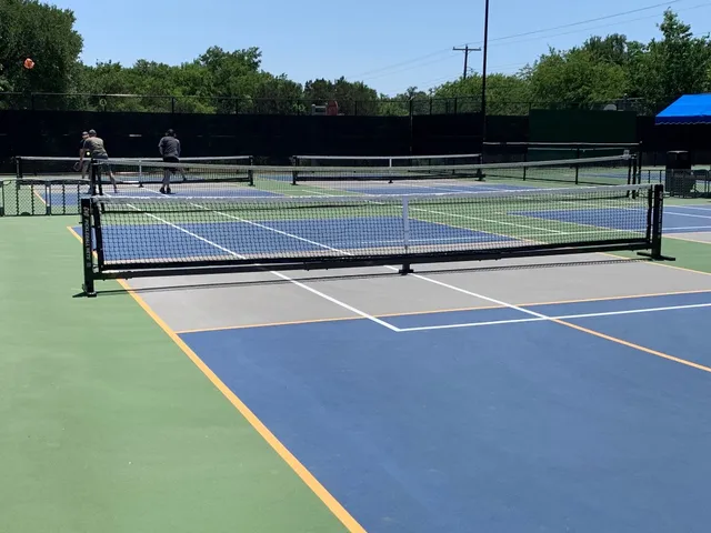 a view of a swimming pool with chairs and a yard