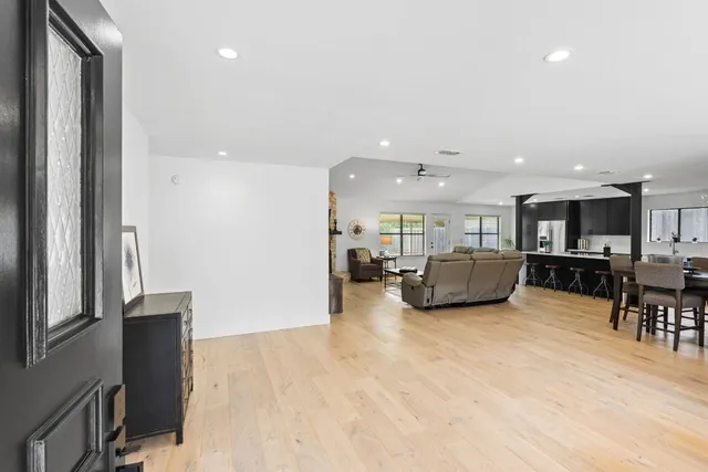 a living room with furniture and kitchen view