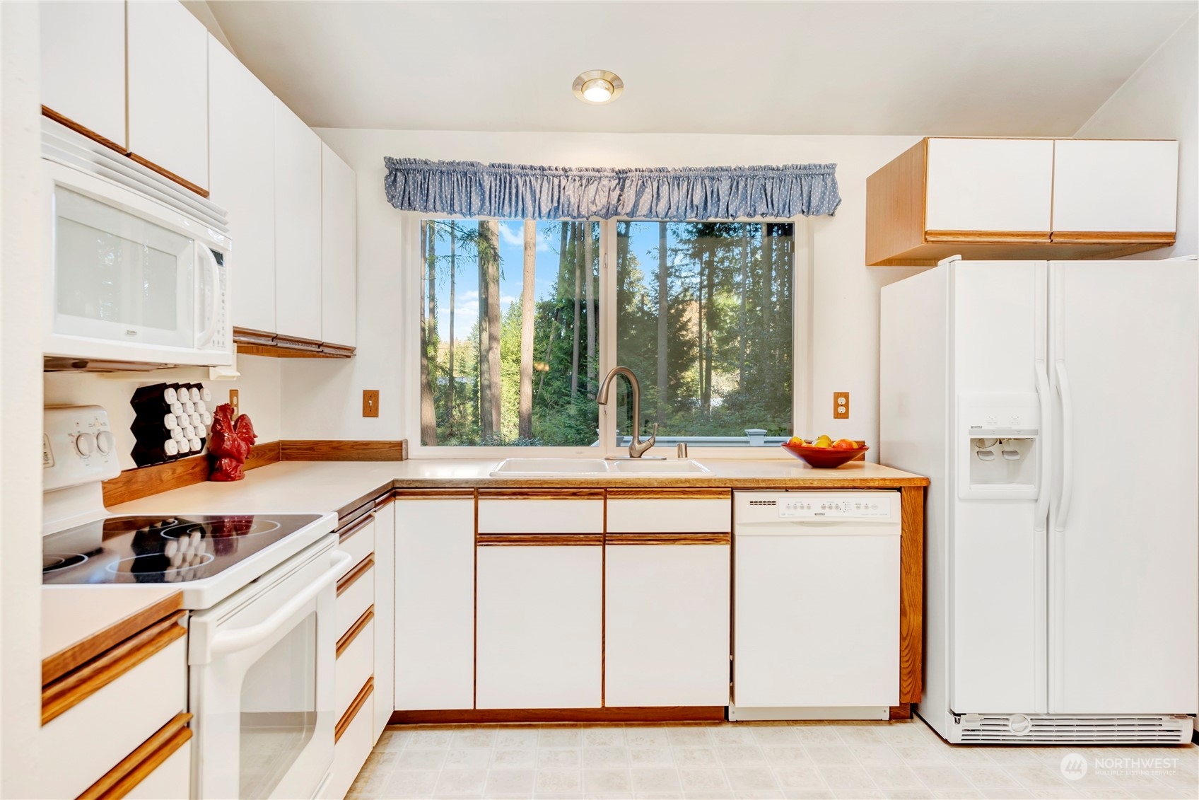 22215 49th Avenue Southeast Bothell, WA 98021 - Photo 11 of 35 a kitchen with a sink a stove and white cabinets