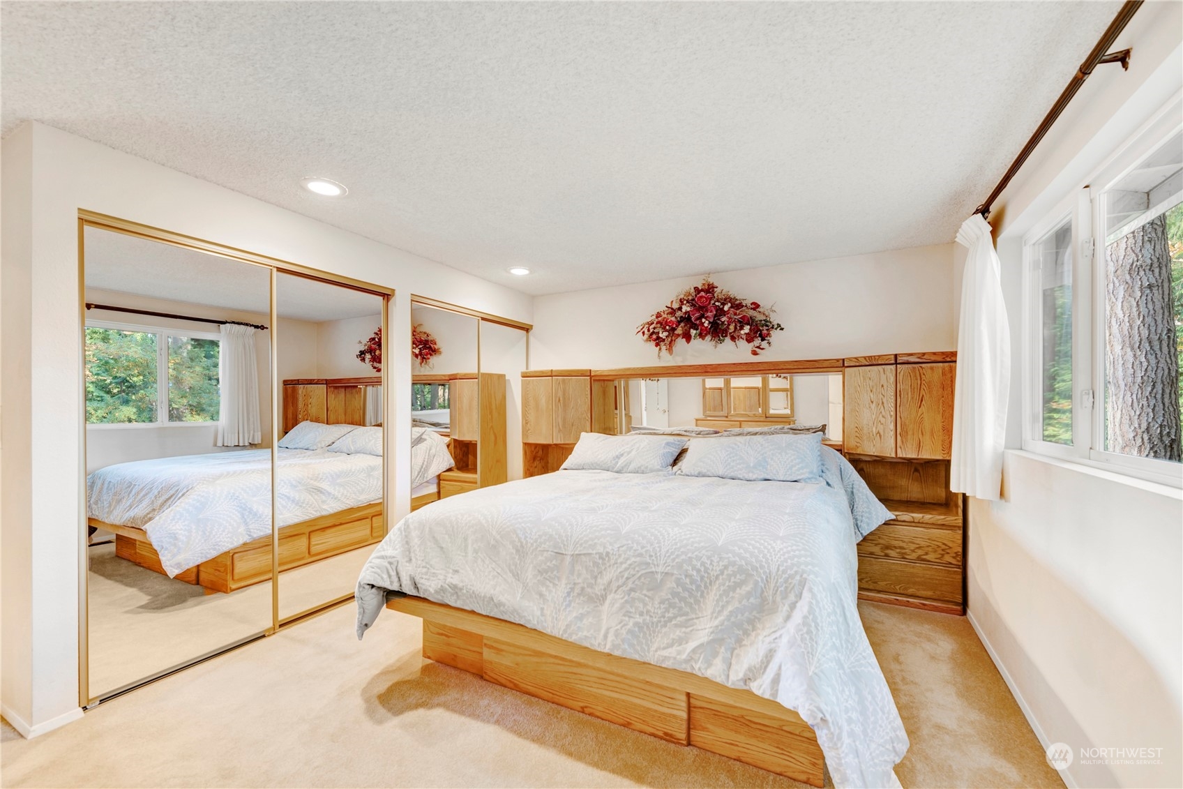 22215 49th Avenue Southeast Bothell, WA 98021 - Photo 14 of 35 a spacious bedroom with a large bed and a chandelier