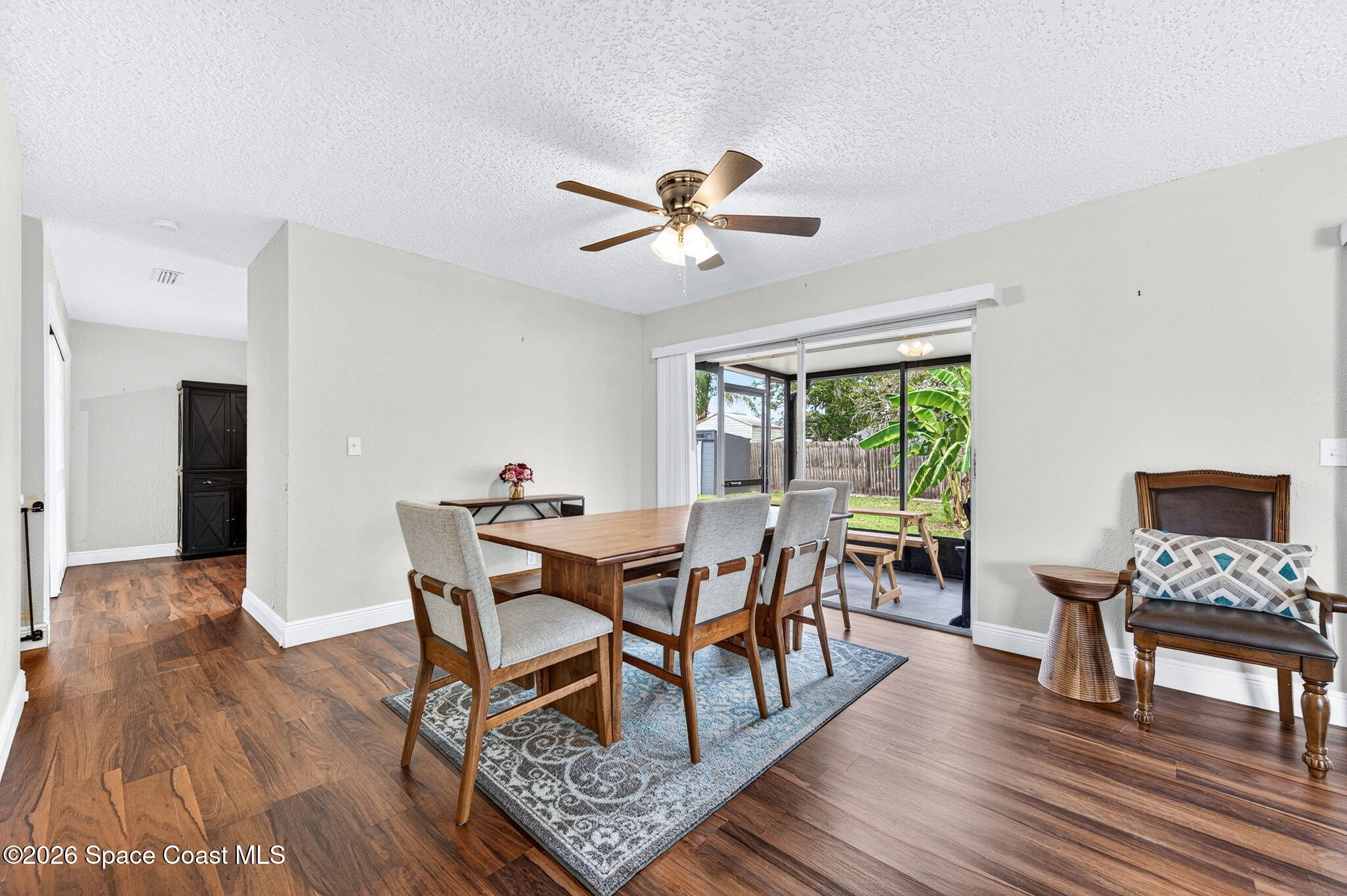 996 Botany Lane Rockledge, FL 32955 - Photo 11 of 35 a dining room with furniture a rug and a chandelier