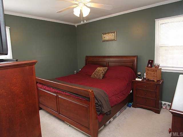 Master bedroom with smooth ceiling, crown molding, updated ceiling fan and designer paint.