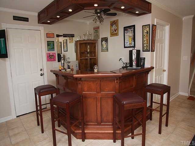 7933 Brandyapple Drive Raleigh, NC 27615 - Photo 8 of 12 Truly unique built in bar with recessed lighting, updated ceramic tile floor and bar fridge.