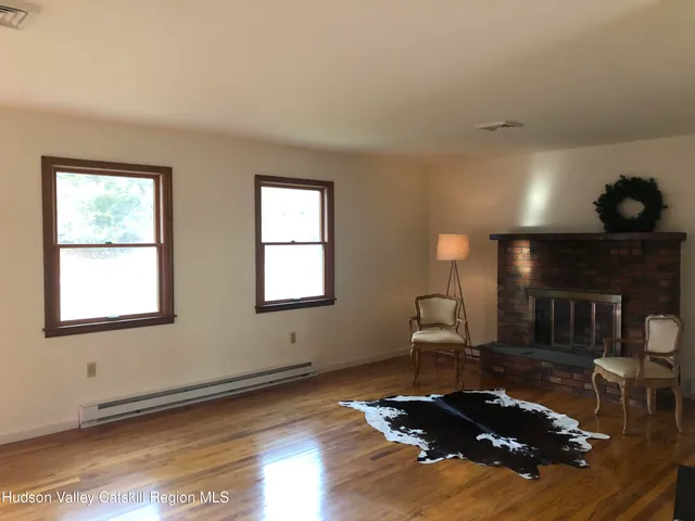 a living room with furniture fireplace and window