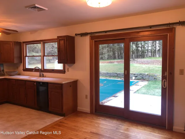 a kitchen with a window and wooden cabinets