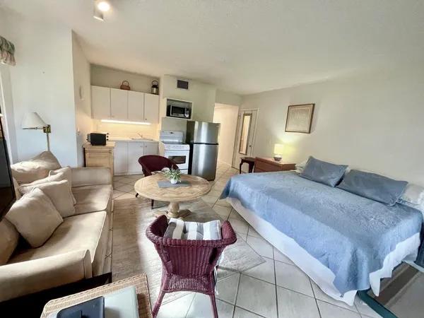 a living room with furniture fireplace and a window