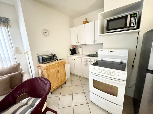 a kitchen with a stove a microwave and a sink