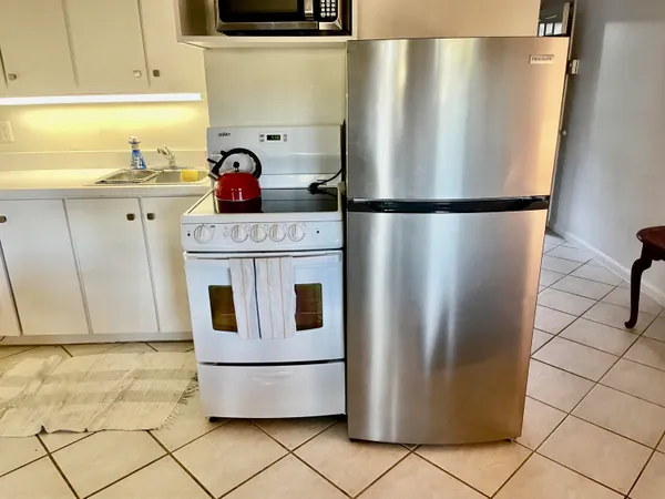 a kitchen with stainless steel appliances granite countertop a refrigerator and a stove