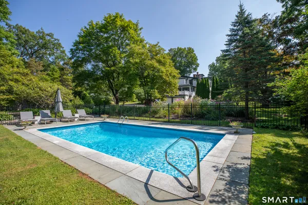 a view of swimming pool with seating space