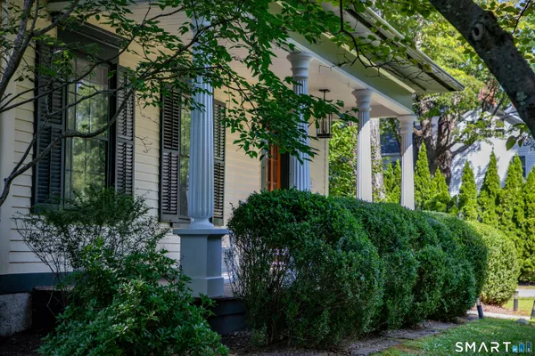 front view of a house with a tree