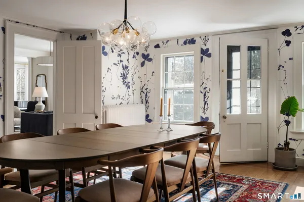 a view of a dining room with furniture and chandelier