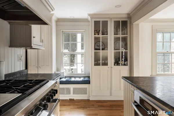 a kitchen with granite countertop a stove and a sink