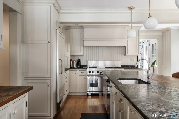 a kitchen with a sink stove and refrigerator