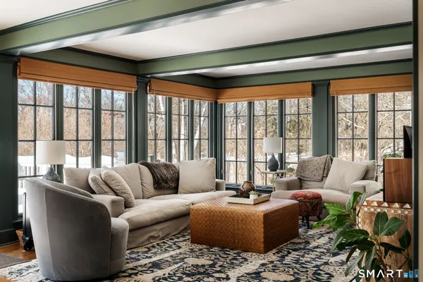 a living room with furniture and floor to ceiling windows
