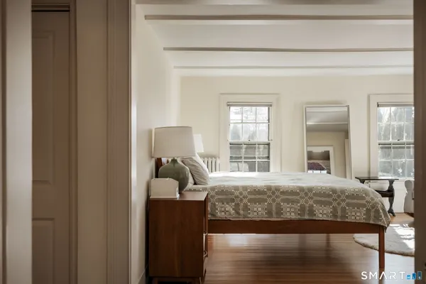 a bedroom with a bed and a large window