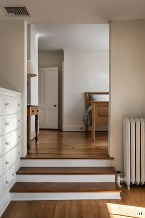 a view of entryway and hall with wooden floor