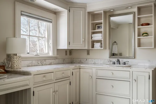 a bathroom with a sink vanity and mirror