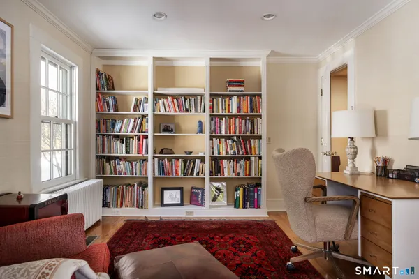 a living room with furniture and a book shelf