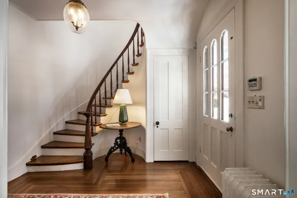 a view of entryway and hall with wooden floor