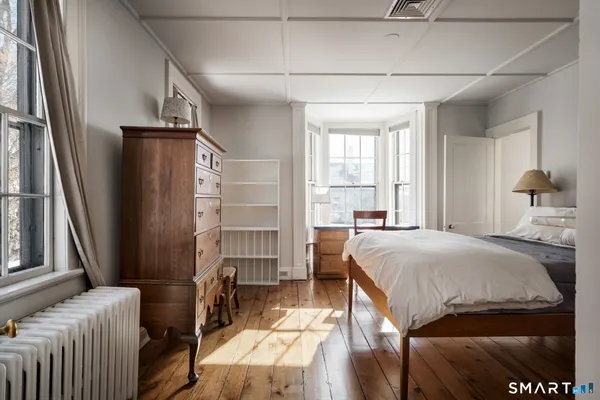 a bed room with a bed and a window