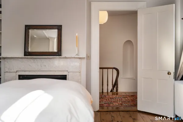 a bedroom with a bed and a mirror