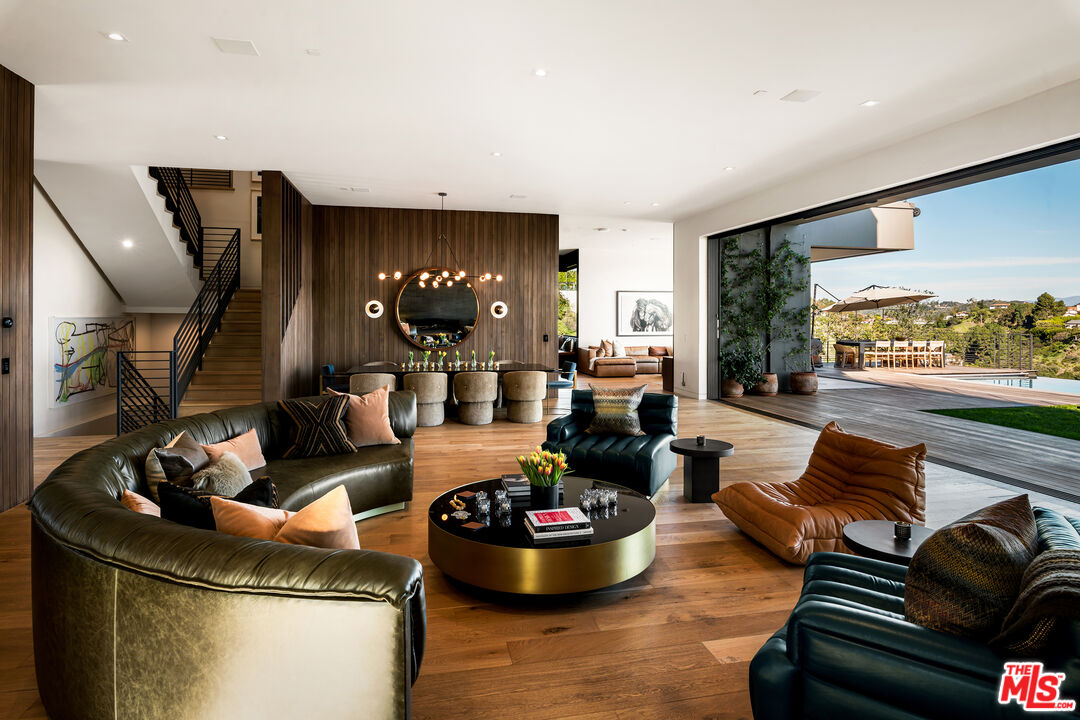 1030 Somera Road Los Angeles, CA 90077 - Photo 12 of 54 a living room with furniture and a floor to ceiling window