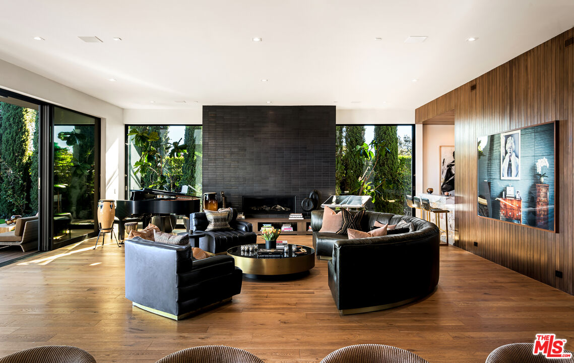 1030 Somera Road Los Angeles, CA 90077 - Photo 13 of 54 a living room with fireplace furniture and a large window