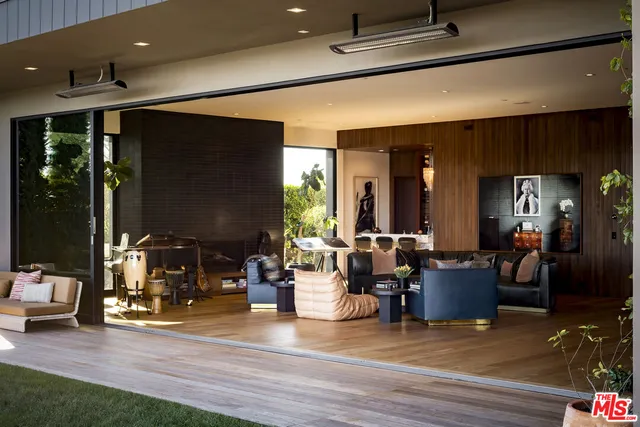 a living room with patio furniture and a fireplace