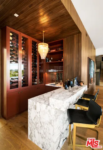 a living room with furniture kitchen view and a large window