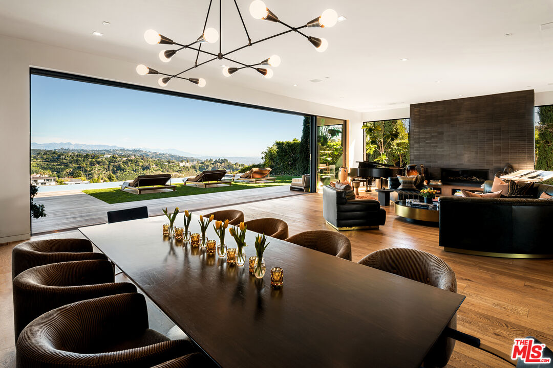 1030 Somera Road Los Angeles, CA 90077 - Photo 20 of 54 a living room with couches and a flat screen tv with kitchen view