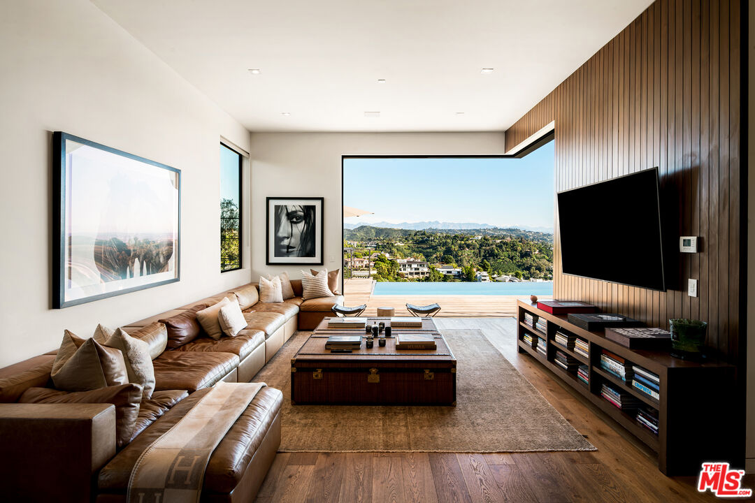 1030 Somera Road Los Angeles, CA 90077 - Photo 21 of 54 a living room with furniture and a flat screen tv