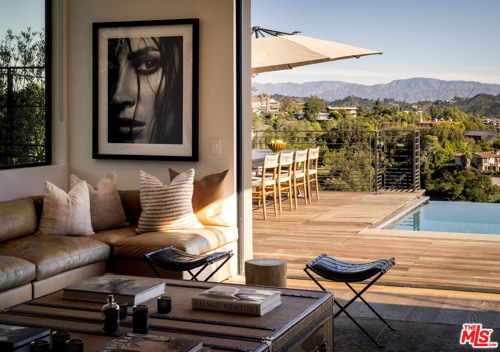 1030 Somera Road Los Angeles, CA 90077 - Photo 22 of 54 a view of a balcony with two chairs and a potted plant
