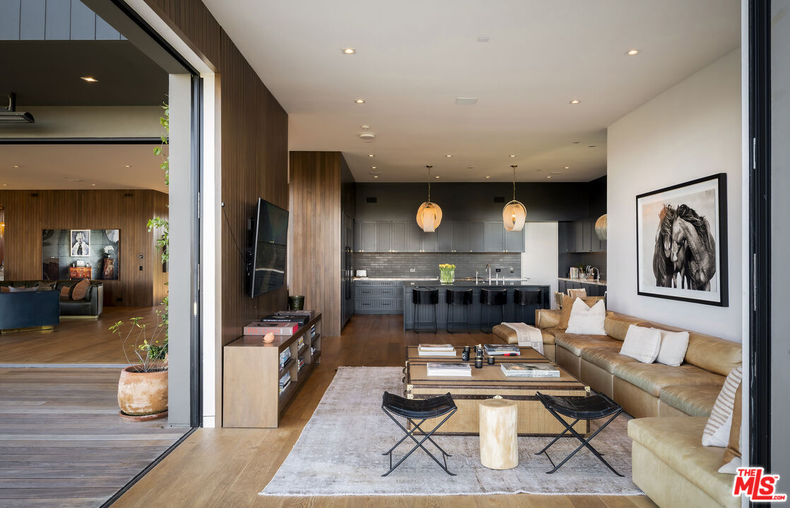 1030 Somera Road Los Angeles, CA 90077 - Photo 23 of 54 a living room with fireplace furniture and wooden floor