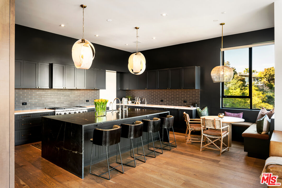1030 Somera Road Los Angeles, CA 90077 - Photo 25 of 54 a kitchen with a table and chairs in it