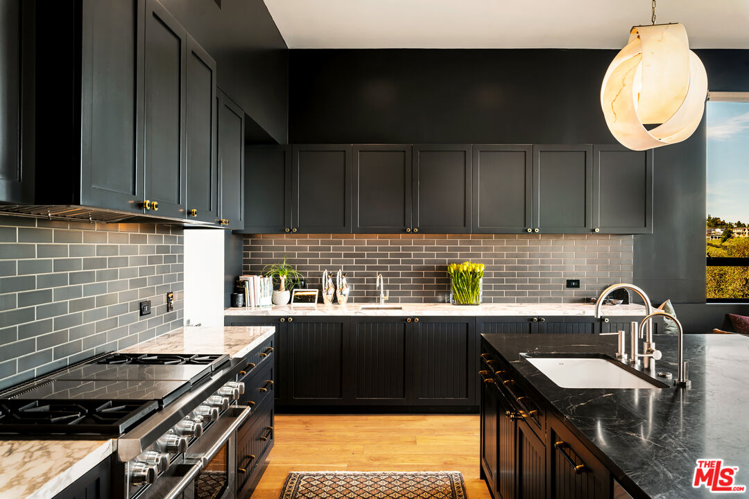 1030 Somera Road Los Angeles, CA 90077 - Photo 26 of 54 a kitchen with a sink stove top oven and cabinets