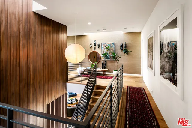 a living room with furniture a flat screen tv and a large window