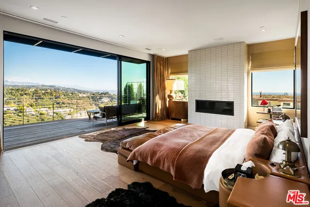 a large white kitchen with a large window and refrigerator