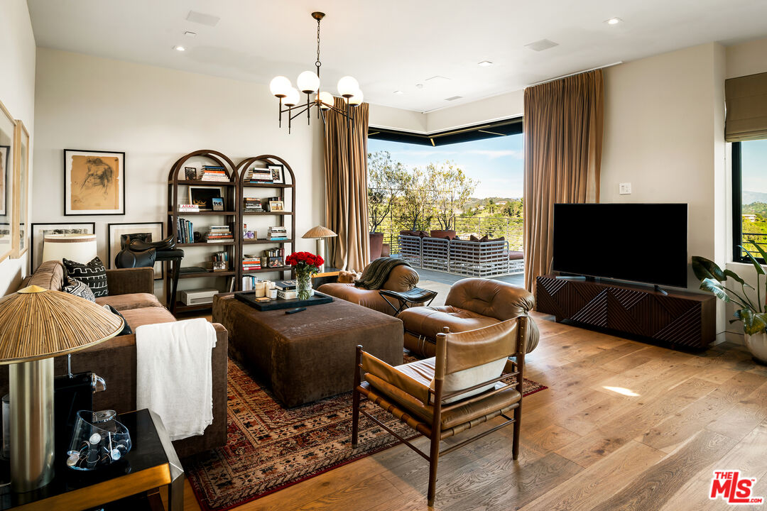 1030 Somera Road Los Angeles, CA 90077 - Photo 32 of 54 a living room with furniture a flat screen tv and a large window